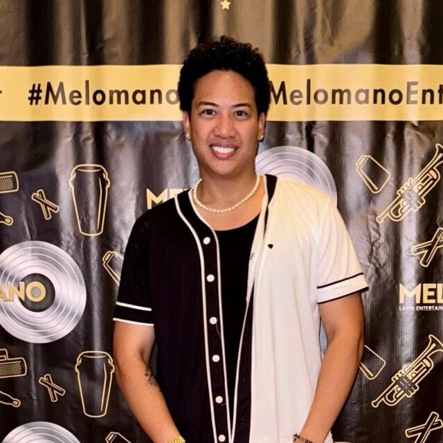Dustin, Dream Team member, posing in front of Melomano Salsa and Bachata poster